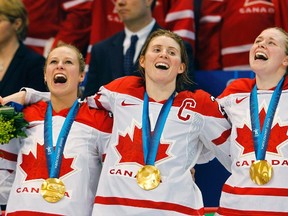 Tessa Bonhomme, Hayley Wickenheiser and Haley Irwin celebrate their gold medal victory over the U.S. at the Vancouver Winter Olympics on Feb. 25, 2010. (Todd Korol/Reuters/Files)