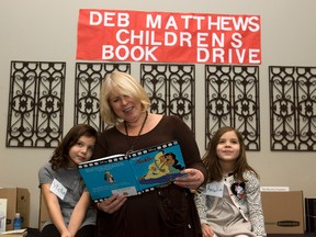 London North Centre Member of Parliament Deb Matthews looks over Aladdin with sisters Stella (7) (left) and Amelia (5) Rossi at the kick off for the ninth annual Deb Matthews Children's Book Drive in London, Ontario on Sunday, January 20, 2013. Books for children and young adults can be dropped off at her constituency office located at 242 Piccadilly Street until February 5. From there the books will be given to needy organizations throughout Ontario. DEREK RUTTAN/ The London Free Press /QMI AGENCY