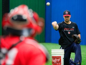 Chris Robinson of Dorchester is walking away from major league baseball and taking up more coaching at training at Centerfield Sports in London, Ont.
Robinson was working with Harrison Leslie, 18 a catcher who goes to school at St. Thomas Aquinas on Tuesday January 14, 2014. Mike Hensen/The London Free Press/QMI Agency