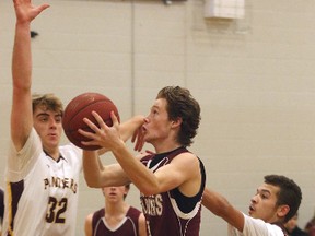 Tristan Halladay of the Frontenac Falcons goes up for a layup in front of Regiopolis-Notre Dame Panthers defenders Duncan Lambert, left, and Deluzio in a Kingston Area Secondary Schools Athletic Association senior boys basketball game Tuesday night at Regi. The visiting Falcons won the game 56-46. (Tim Gordanier/The Whig-Standard)