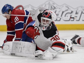 New Jersey Devils goaltender Martin Brodeur makes a stop on Montreal Canadiens forward Daniel Briere at the Bell Centre in Montreal, Jan. 14, 2014. (MARTIN CHEVALIER/QMI Agency)