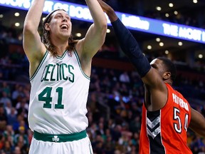 Canadian Kelly Olynyk of the Celtics takes a shot over Raptors' Patrick Patterson in Boston last night.