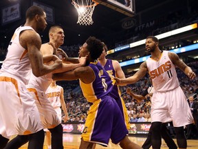 Nick Young of the Los Angeles Lakers (middle) pushes Alex Len of the Phoenix Suns after a flagrant foul as Marcus Morris (left) and Markieff Morris (right) look on during first half NBA action in Phoenix on Wednesday, Jan. 15, 2014. (Christian Petersen/Getty Images/AFP)