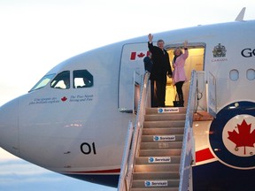 Canada's Prime Minister Stephen Harper (L) and wife Laureen board the Royal Canadian Air Force Airbus CC-150 in Ottawa on December 8, 2013. (REUTERS files/Blair Gable)