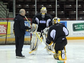 Sarnia Sting goalie coach Dave Rook instructs his charges, Brodie Barrick (standing) and Taylor Dupuis prior to practice on Thursday, Jan. 16. The Sting have gotten very solid goaltending over the last stretch of games, and it is something head coach Trevor Letowski hopes will continue this weekend. (SHAUN BISSON, The Observer)