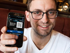 Kyle Kemper, Head of Venture Capital for BiT Capital, displays a digital Bitcoin wallet on a smartphone. January 16, 2014. Errol McGihon/Ottawa Sun/QMI Agency