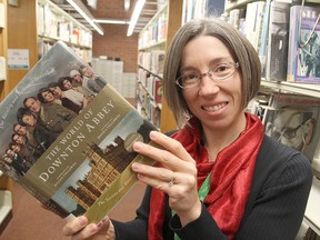 Kimberly Sutherland Mills, the manager of programming and outreach at the Kingston Frontenac Public Library, holds a book on Downton Abbey, the PBS television series that will be the subject of a month of special events at the library.
Michael Lea The Whig-Standard