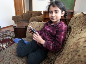 Kamolpreet Kaur, 7, plays in her family's home in the Maples on Thu., Jan. 16, 2014. She was in her mother Parmjeet's car on their front street when a man approached her mother, demanded her keys, and stabbed her in the leg. Parmjeet was able to get Kamolpreet out of the vehicle before the man drove off. Kevin King/Winnipeg Sun/QMI Agency