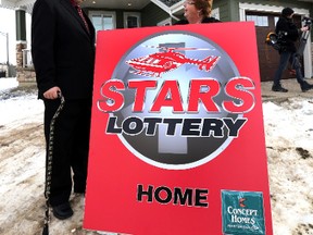 Stars Patient RCMP Constable Marcus Hirschfield (l) chats with STARS Development Officer, Maureen Henkel during the STARS Lottery 2014 launch in Edmonton, Alta., on Tuesday Jan. 15, 2014.  Perry Mah/Edmonton Sun