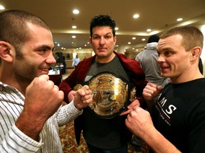 Tom Gallicchio, left and Kurt Southern pose at a pre-fight event Wednesday at the Sutton Place Hotel as MFC owner Mark Pavelich holds up the organization's lightweight belt. (Perry Mah, Edmonton Sun)