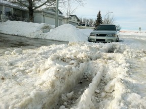With the heavy snowfall this winter followed by a fast melt, many residential streets have turned into a mess of ruts and are impassable. (TOM BRAID/Edmonton Sun)