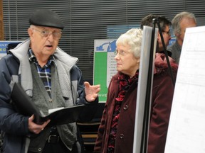 W. BRICE MCVICAR The Intelligencer
Rod Bovay, the city's director of engineering, discusses the sewer extension program along Dundas Street West to property owners Doug and Jackie Wright during an information session Thursday night. The $3.5-million project is expected to begin in March.