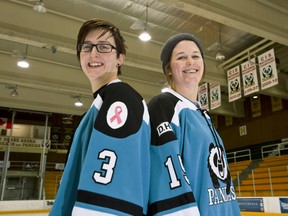 University of Alberta Pandas assistant coach Sarah Hilworth (left) and Pandas forward Katie Stewart wear hockey jerseys that will be worn in an upcoming Jan. 18 game against the UBC Thunderbirds to fundraise for Ovarian Cancer Canada. (Ian Kucerak, Edmonton Sun)