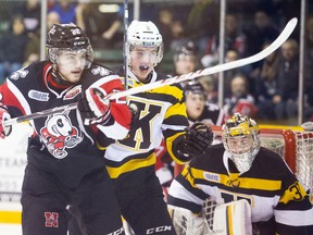 Ben Hughes of the Niagara IceDogs and Evan McEneny of the Kingston Frontenacs battle in front of the net during first-period action at the Jack Gatecliff Arena in St. Catharines Thursday night. (Julie Jocsak/QMI Agency)