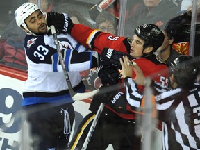 Dustin Byfuglien tangles with Shane O'Brien during the Jets-Flyers tilt in Calgary Thursday. (STUART DRYDEN/QMI Agency)