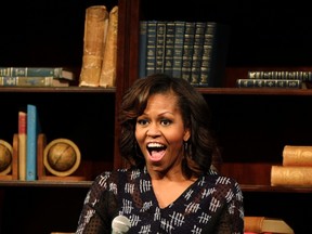 U.S. first lady Michelle Obama reacts during a virtual discussion event with youths at the Sci-Bono Discovery Centre in Johannesburg June 29, 2013. REUTERS/Thomas Mukoya