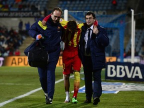 Barcelona's Brazilian forward Neymar da Silva Santos (C) is helped off the field during a Spanish Copa del Rey (King's Cup) round of 16 second-leg football match against Getafe CF. (AFP)