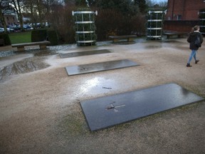Three headstones mark the spot of the former Hyde Abbey, where a pelvic bone that could potentially belong to either King Alfred the Great or his son Edward the Elder was found, in Winchester, southern England Jan. 17, 2014. REUTERS/Kieran Doherty