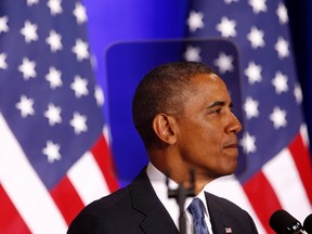 U.S. President Barack Obama is seen through a teleprompter as he speaks about the National Security Agency from the Justice Department in Washington January 17, 2014. REUTERS/Kevin Lamarque