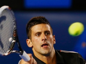 Novak Djokovic hits a return to Denis Istomin during their match at the Australian Open in Melbourne January 17, 2014. (REUTERS/Petar Kujundzic)