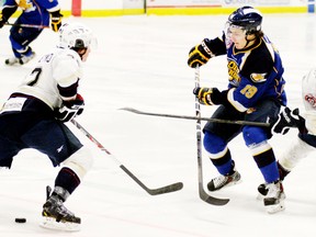 The Saints (white jerseys) and the Oil Barons will be eyeing each other up, and lining each other up, as they meet twice more down the stretch run as the AJHL regular season schedule begins to wind down. - Gord Montgomery, Reporter/Examiner