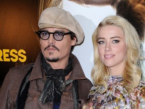 U.S. actors Johnny Depp, left, and Amber Heard pose for photographers during a photocall for the film "The Rum Diary" in Paris November 8, 2011. (REUTERS/Gonzalo Fuentes)