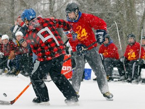 Action between 24 CF Health Services (red and yellow jersey) and BCR Rangers at the Third Annual CFB Trenton Pond Hockey Classic in Batawa, Quinte West, Ont. Friday, Jan. 17, 2014. - JEROME LESSARD/The Intelligencer/QMI Agency