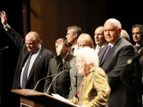 Toronto Mayor Rob Ford raises his hand indicating he thought Premier Kathleen Wynne should have attended a meeting of GTA mayors in Mississauga on Jan. 17, 2014 to discuss provincial and federal financial help for the ice storm cleanup. (Stan Behal/Toronto Sun)