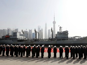 Members of the People's Liberation Army Navy stand in formation as they welcome visiting Pakistan Naval vessel PNS Nasr at Shanghai Port International Cruise Terminal, opposite the Pudong financial area, in Shanghai. 
REUTERS/Stringer