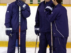 Paul Maurice, left, Dallas Eakins, right, and Randy Ladouceur chat during a Leafs practice in 2006. (QMI Agency file)
