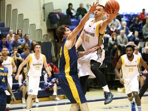 OUA men's basketball action featuring Laurentian Voyageurs and Queen's Gaels at Laurentian University on Friday. JOHN LAPPA/THE SUDBURY STAR/QMI AGENCY