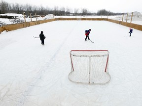 Kids play on an outdoor hockey rink at Creekside Gardens in Richmond, Ont. on Friday January 17, 2014. A local businessman donated the rink to the village for kids to play hockey on.
Darren Brown/Ottawa Sun/QMI Agency