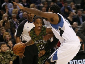 DeMar DeRozan drives against Timberwolves' Dante Cunningham in the first half at the ACC on Friday night. (Michael Peake/Toronto Sun)