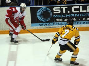 Former Sarnia Sting, and current Sault. Ste. Marie Greyhounds forward forward Bryan Moore takes the puck wide on Sting defenceman Anthony DeAngelo early in the first period of their game on Friday, Jan. 17 at the RBC Centre. Moore scored on the play, the first goal in a 6-2 win for the Greyhounds. SHAUN BISSON/THE OBSERVER/QMI AGENCY