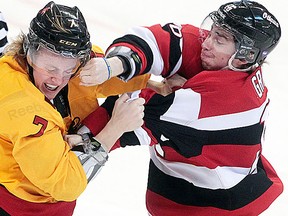 Belleville Bulls rookie Andrew Ming exchanges blows with Ottawa's Connor Graham during OHL action Friday night in Ottawa. (TONY CALDWELL/Ottawa Sun)