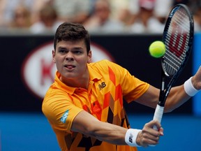Milos Raonic hits a return to Grigor Dimitrov during their men's singles match at the Australian Open in Melbourne, Jan. 18, 2014. (BOBBY YIP/Reuters)