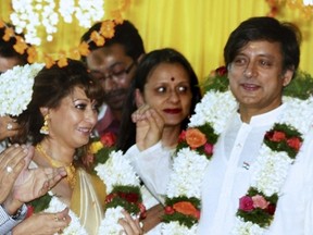 In this photograph taken on August 22, 2010 Indian parliamentarian Shashi Tharoor (R) and his bride Sunanda Pushkar Sunday (L) take part in their wedding ceremony in Pallakad.  The wife of prominent Indian minister Shashi Tharoor was found dead January 17, 2014 in a five-star hotel room after she exposed his alleged adultery with a Pakistani journalist on Twitter, media reports said.  AFP PHOTO/FILES