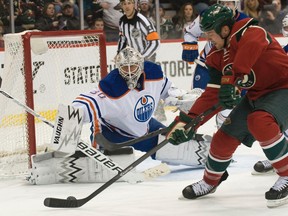 Ben Scrivens gets across to block a Kyle Brodziak backhand during his debut in the Oilers net on Thursday against the Wild. (USA Today Sports)