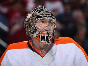 Goaltender Steve Mason of the Philadelphia Flyers looks up to the crowd during a break from an NHL game against the Phoenix Coyotes at Jobing.com Arena on January 4, 2014 in Glendale, Arizona. (Christian Petersen/Getty Images/AFP)