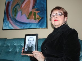 Betty-Lou Sandlos holds a picture of her brother, David Buller, who was brutally killed in 2001. Police have not yet caught his killer. (Morgan Ian Adams/QMI Agency)