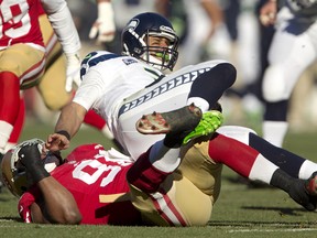 Defensive tackle Ray McDonald #91 of the San Francisco 49ers sacks quarterback Russell Wilson #3 of the Seattle Seahawks in the second quarter on December 8, 2013 at Candlestick Park in San Francisco, California. The 49ers won 19-17.  (Brian Bahr/Getty Images/AFP)