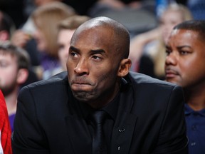 Kobe Bryant of the Los Angeles Lakers watches his team from the bench against the Dallas Mavericks on January 7, 2014 at the American Airlines Center in Dallas, Texas. (AFP)