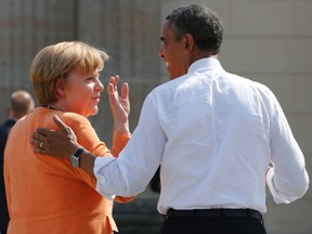 File photo of U.S. President Barack Obama chating with German Chancellor Angela Merkel after their speeches at the Brandenburg Gate in Berlin, June 19, 2013. REUTERS/Wolfgang Rattay/Files
