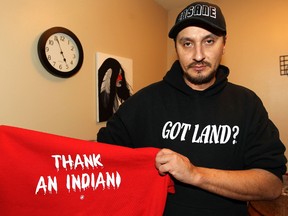 Jeff Menard displays the front and back of a shirt design on Sat., Jan. 18, 2014 that he hopes will become a national phenomenon after a Saskatchewan teen was told he couldn't wear it at his school. (Kevin King/Winnipeg Sun/QMI Agency)