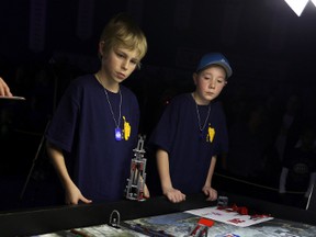 Jayden Dest (l) Brent Grutterink from the Rimbey Ramboticss watch their robot in action during the Lego Robotics Championship at NAIT in Edmonton, AB., on Saturday, Jan 18, 2014.  Perry Mah/Edmonton Sun/ QMI Agency