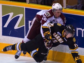 Sarnia Sting forward Davis Brown is tackled by Peterborough Petes' Alan Quine during a game in Peterborough on Dec. 1, 2012. Sarnia made their return to Peterborough on Saturday night, and fell 7-4 to the Petes. OBSERVER FILE PHOTO