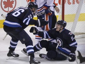 Winnipeg Jets Blake Wheeler (left) celebrates after Mark Scheifele scored against the Edmonton Oilers during NHL action at MTS Centre in Winnipeg, Man. on Sat., Jan. 18, 2014. Kevin King/Winnipeg Sun/QMI Agency