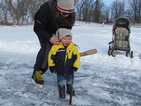 Brittany Pyne adjusts the hat of one-year-old Knox Pyne as the Bright's Grove family was playing hockey on the weekend on frozen Lake Chipican in Sarnia. Environment Canada says another blast of cold Arctic air is on its way to Ontario.

PAUL MORDEN /THE OBSERVER/QMI AGENCY