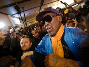 Retired U.S. basketball star Dennis Rodman is surrounded by journalists upon his arrival at Beijing Capital International Airport in this file photo taken January 13, 2014. (REUTERS/Kim Kyung-Hoon/Files)