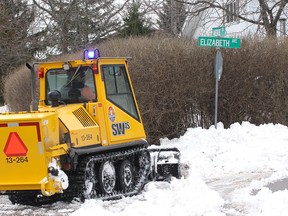 A sidewalk plow clears snow at the corner of Avenue Road and Elizabeth Avenue in this Whig-Standard file photo. (Ian MacAlpine Whig-Standard file photo)